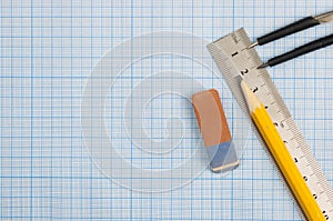 Still life photo of engineering graph paper with a fine 0.1mm pen, compass and ruler, blank to add your own design, image or text