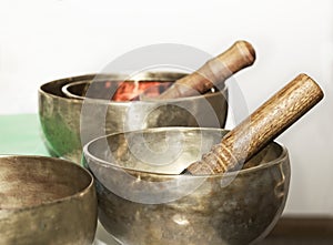 Still life photo with tibet singing bowls close up. Tibetian singing bowls in light blurry background.Asian music instruments. Med