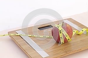 Still Life photography with an apple, tape mesaure and a scale photo