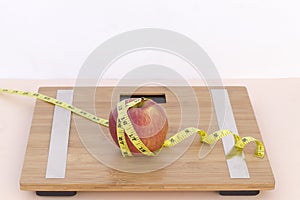 Still Life photography with an apple, tape mesaure and a scale photo