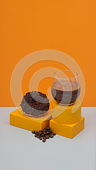 still life photography a cup of coffe and many coffe beans also a donut with chocolate topping