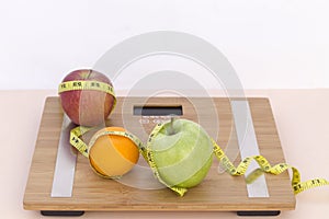 Still Life photography with fruits, tape mesaure and a scale photo