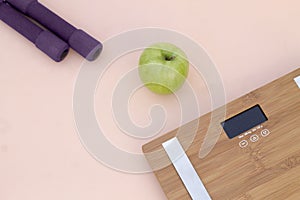 Still Life photography with a green apple, weight and a scale photo