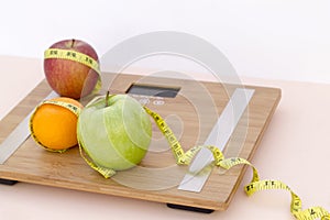 Still Life photography with fruits, tape mesaure and a scale photo