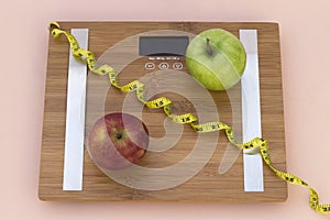 Still Life photography with two apples, tape mesaure and a scale photo