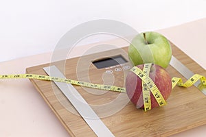 Still Life photography with two apples, tape mesaure and a scale photo