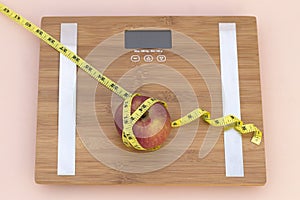 Still Life photography with an apple, tape mesaure and a scale photo