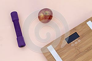 Still Life photography with a red apple, weight and a scale photo