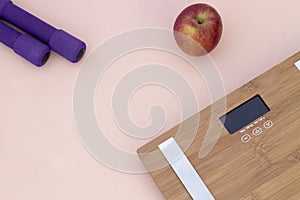 Still Life photography with a red apple, weight and a scale photo