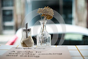 Still life photography shot of dry flowers in a glass vase with a blurred background