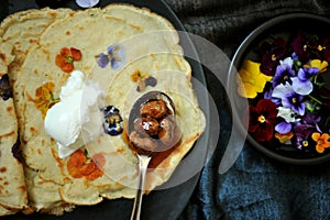 Still life photography of slow living concept with edible flowers crepes as a healthy and happy snack