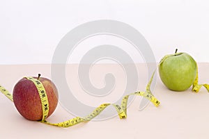 Still Life photography with two apples, tape mesaure photo