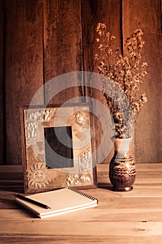 Still life picture frames, vases, dried rose notebook concept frequent memories