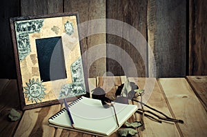 Still life picture frames, vases, dried rose notebook concept frequent memories