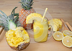 Still life. Pineapple juice, cocktails with fresh pineapple for breakfast in the morning on a wooden tray. Detox.