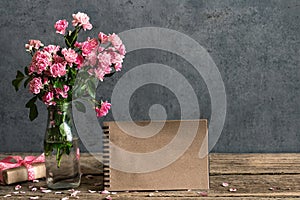 Still life with pink rose flowers bouquet, blank paper card and gift box. mock up. vintage toning