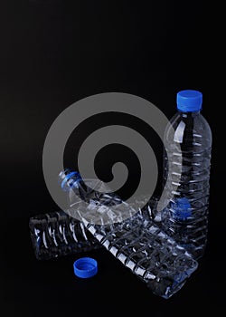 Still life of plastic bottle on black backgrounds vertical