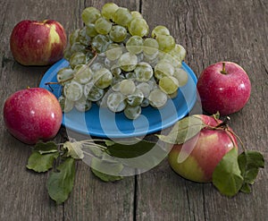 Still life plate of grapes and four apples