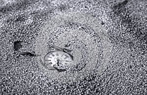 Still life - Pocket watch buried partial in the sand