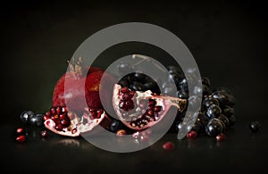 Still life of pomegranate and grapes