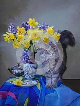 Still life with pretty kitty and bouquet of spring flowers