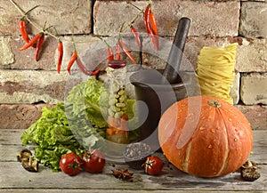 Still life with pumpkin and mortar and pestle