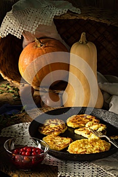 Still life with pumpkin and pancakes in village
