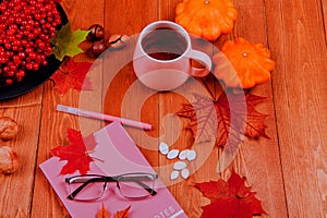 Still life with pumpkin - Pattinson.A notebook with a fountain pen, a glass of tea. Glasses