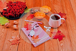 Still life with pumpkin - Pattinson.A notebook with a fountain pen, a glass of tea. Glasses