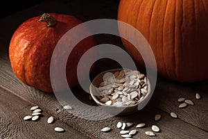 Still life with pumpkins and sunflower seeds on a wooden background, happy thanksgiving