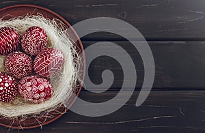 Still life with Pysanka, decorated Easter eggs, on black wooden