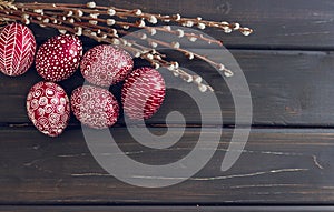 Still life with Pysanka, decorated Easter eggs, on black wooden