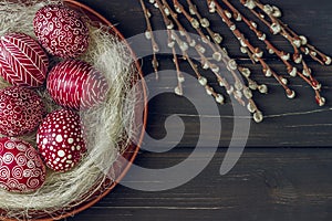 Still life with Pysanka, decorated Easter eggs, on black wooden