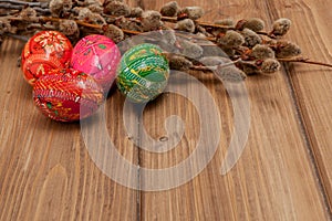 Still life with Pysanka, decorated Easter eggs, dry willow branches on black wooden background, top view, copy space