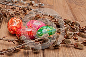 Still life with Pysanka, decorated Easter eggs, dry willow branches on black wooden background, top view, copy space