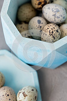 Still life. Quail eggs in a ceramic plate on a textured background. Rustic. Easter celebration concept