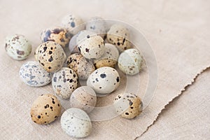 Still life. Quail eggs on a textile napkin. Rustic. Easter celebration concept