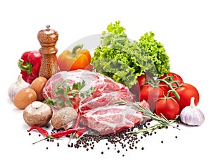 Still life with raw pork meat and fresh vegetables