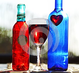 Still life red blue wine glass bottles & heart & pottery charms