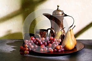 Still life of red grapes and bosc pears