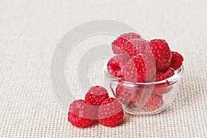 Still life with red raspberry and glass bowl