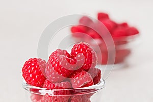 Still life with red raspberry and glass bowl