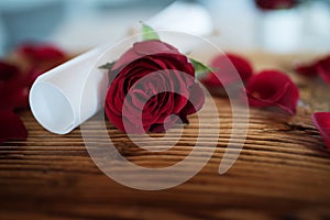 Still life with red rose and letter