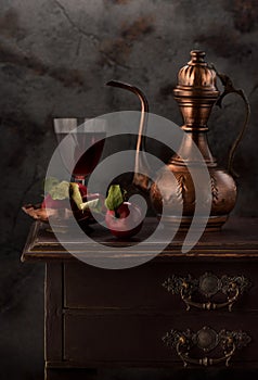 Still life with red wine, antique copper jug and apples photo