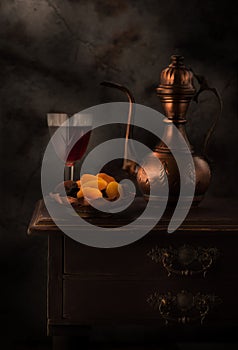 Still life with red wine and dried apricots photo