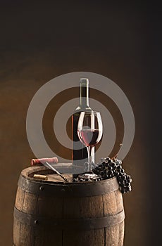 Still life with red wine and wood barrel