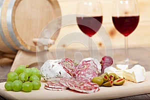 Still life with red wine and wooden cask.