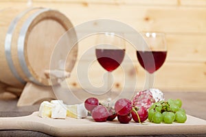 Still life with red wine and wooden cask.