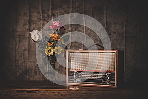 Still life with a retro radio receiver and flower vases