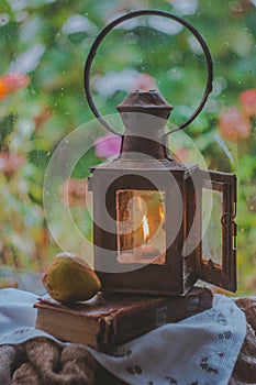 Still life in retro style. Rerto lamp, book and pear. Autumn mood